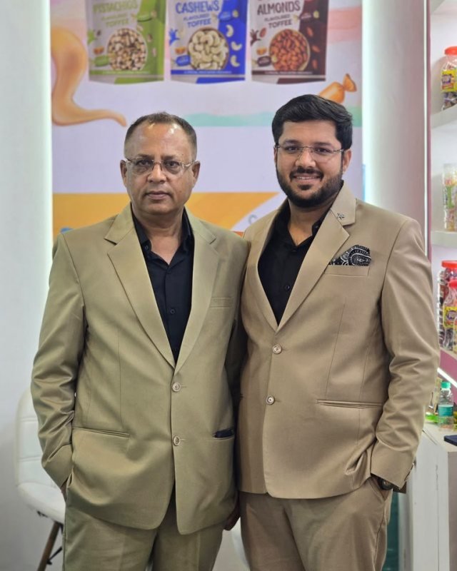 Krishna Confectionery's owners at the company stand, in front of the dry fruit flavoured toffee display